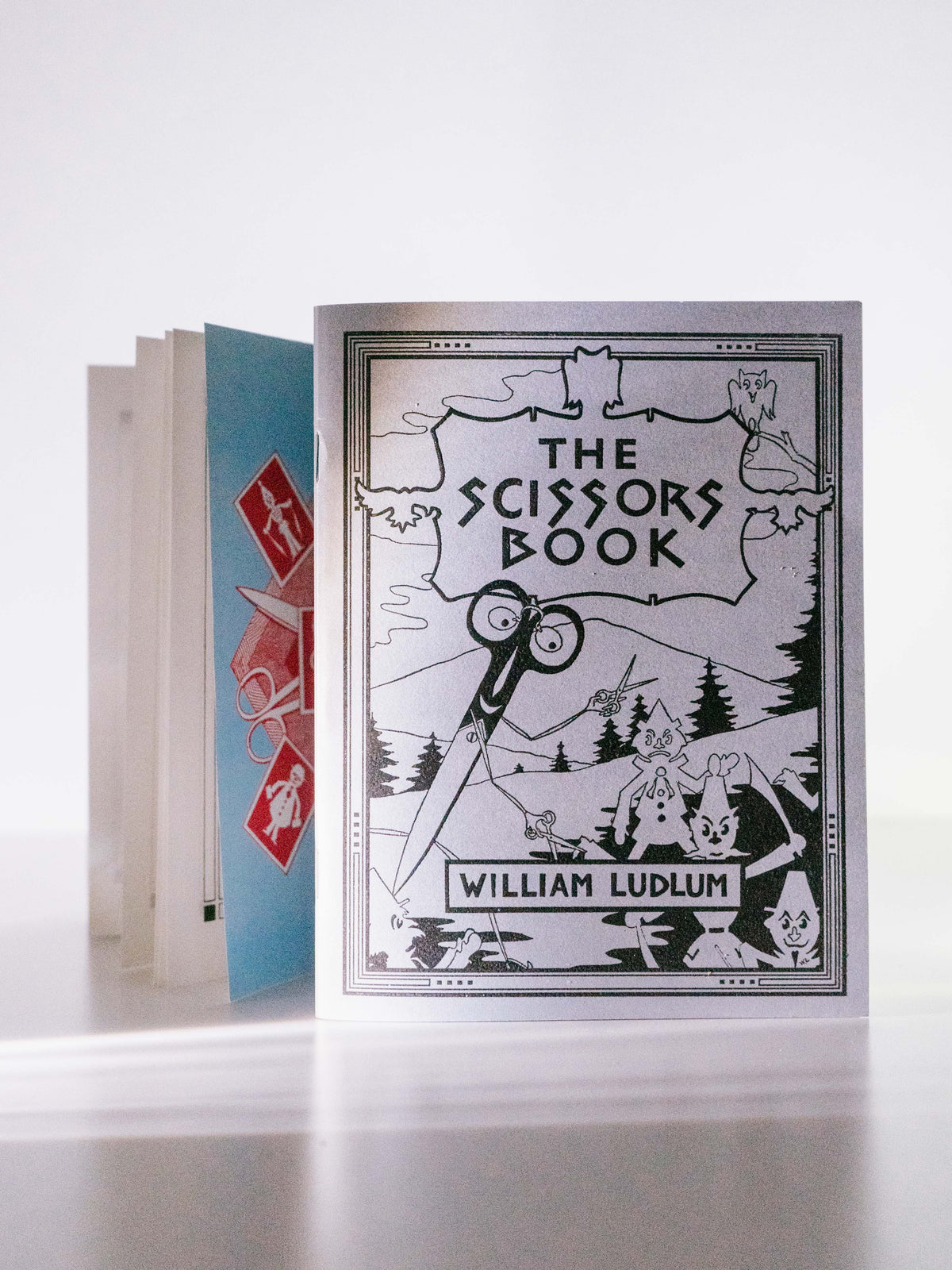 Book titled 'The Scissors Book' by William Ludlum on a white background