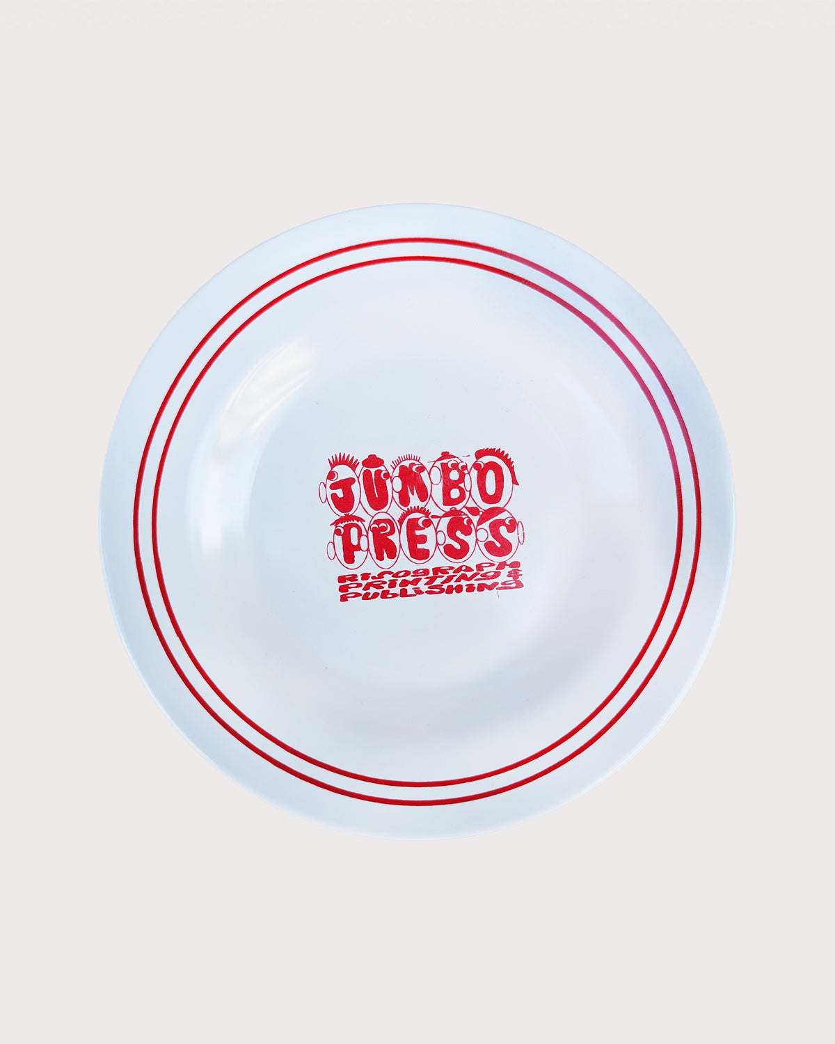 White plate with red text and border on a beige background