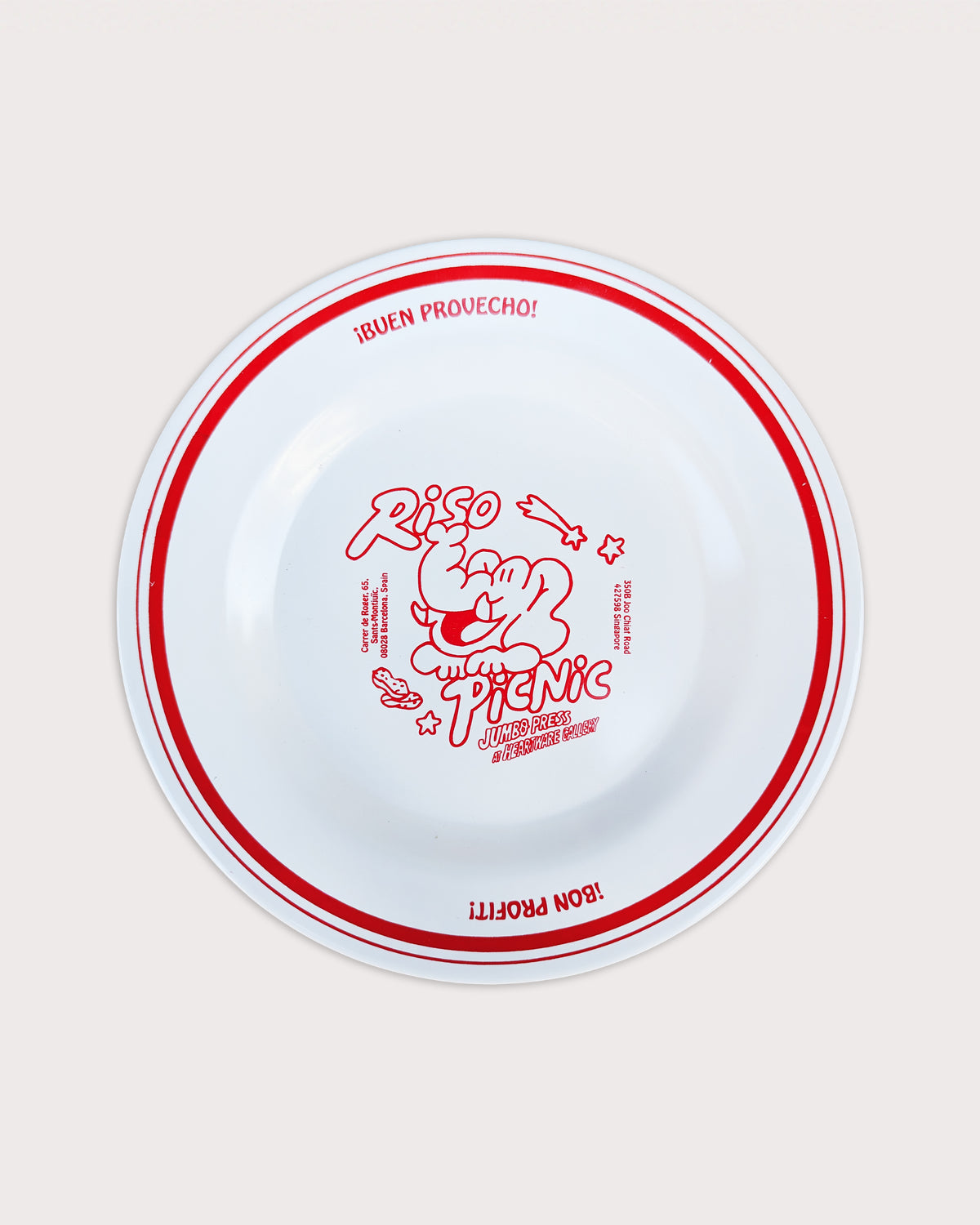 White plate with red decorative rim and text on a beige background